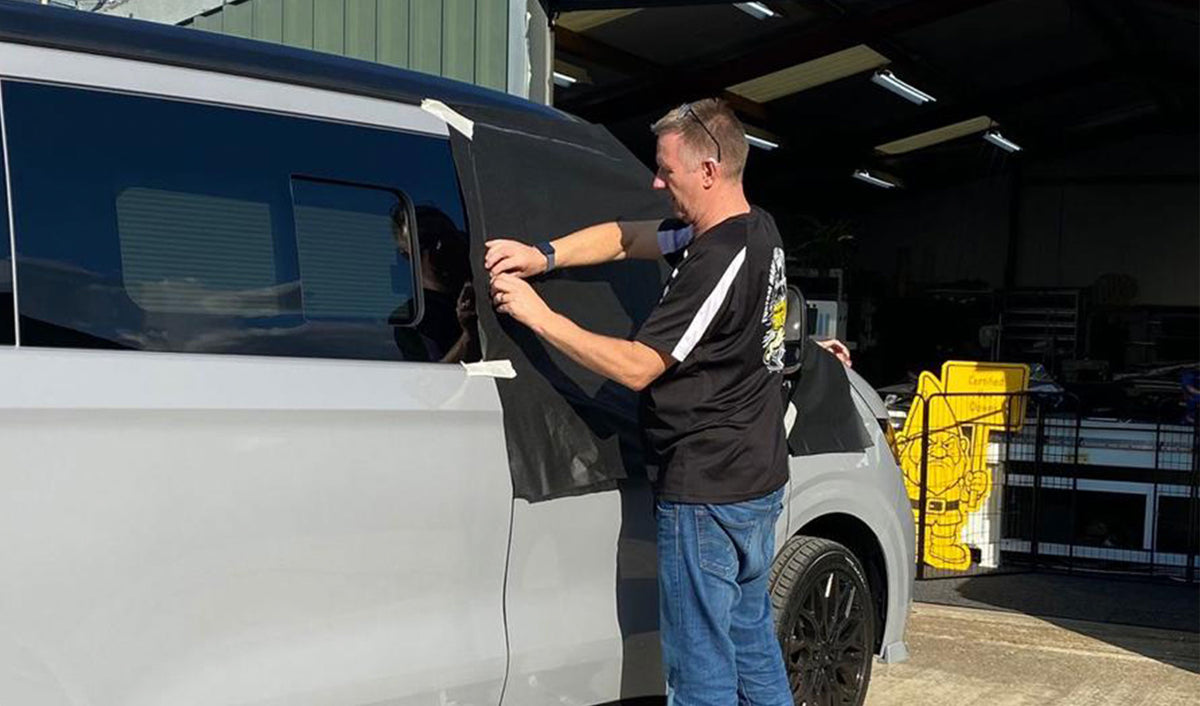 A Kent Dubs screen cover being demonstrated on a campervan